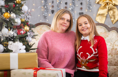 Mom and daughter on sofa in Christmas interior