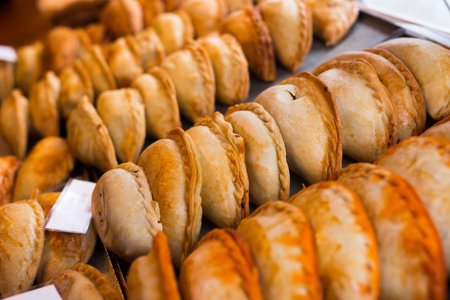 Freshly baked empanadas with different fillings for saleの写真素材