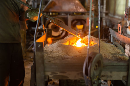 Foundry - ferrous metal is melted in an induction furnace of metallurgical plantの写真素材
