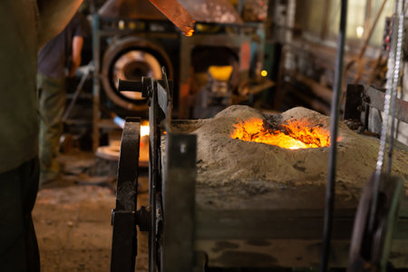 Foundry - ferrous metal is melted in an induction furnace of metallurgical plantの写真素材