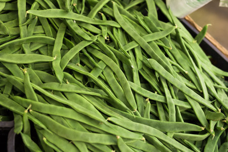 Green romano beans on the counter in the market