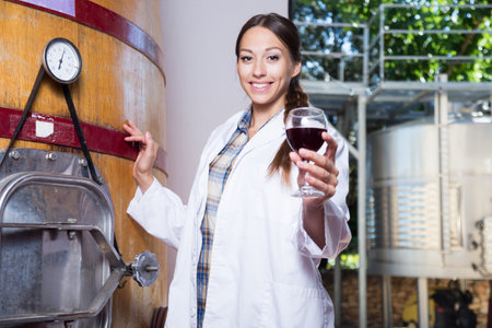 Woman in white coat on the winery