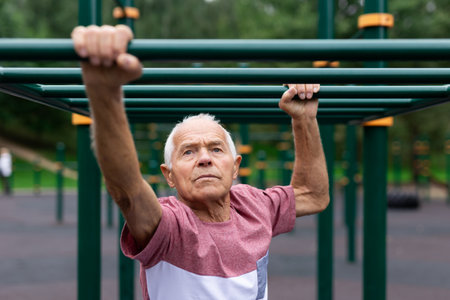 Old climbing on horizontal ladder outdoors