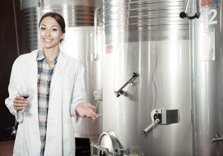 woman sommelier is tasting wine at wine factoryの写真素材