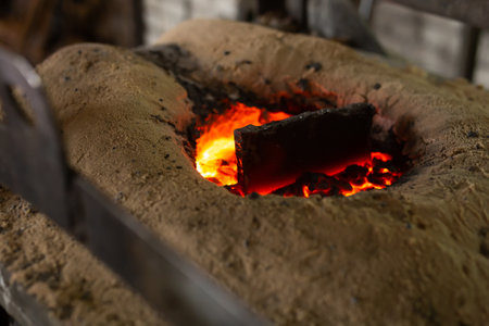 Ferrous metal billet is melted in an induction furnace closeup