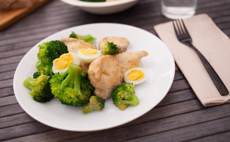 Chicken breast with broccoli and quail eggs on plate for healthy dinnerの写真素材