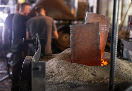 Foundry - ferrous metal is melted in an induction furnace of metallurgical plantの写真素材