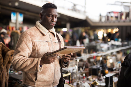 Man chooses antiques at a flea marketの写真素材