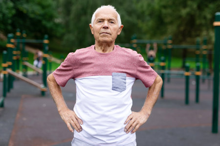 Senior man in sportswear standing in outdoor playgroundの写真素材