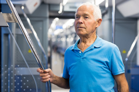 Portrait of mature male passenger riding in subway wagonの写真素材
