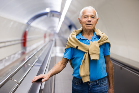 Old man standing on travolatorの写真素材