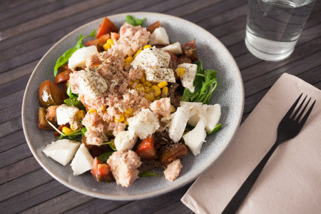 Plate of salad with tuna, corn, tomatoes and arugulaの写真素材