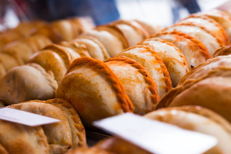 Freshly baked empanadas with different fillings for saleの写真素材
