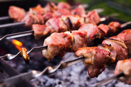 Juicy cuts of meat are grilled on grill. Outdoor recreation conceptの写真素材