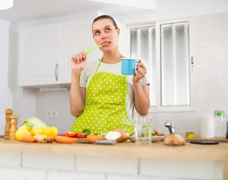 Dreamy girl in with vegetable on table in kitchenの写真素材