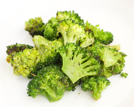Fried inflorescences of broccoli with provencal herbs on white plateの写真素材