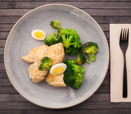 Chicken breast with broccoli and quail eggs on plate for healthy dinnerの写真素材