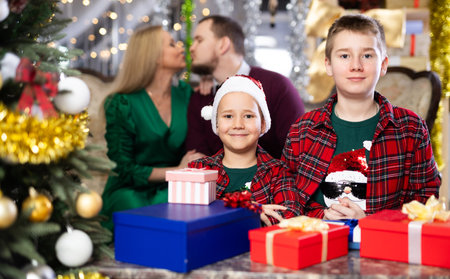 Smiling family celebrating Christmas and giving each other giftsの写真素材