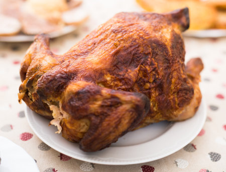 Whole roasted chicken on a plateの写真素材