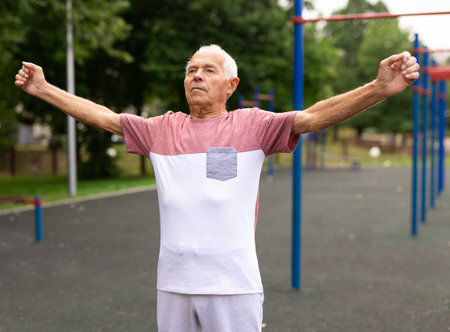 Senior man doing warming up exercisesの写真素材