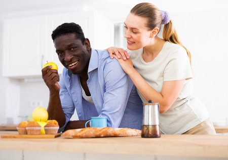 Wife and husband having breakfast in modern kitchen at homeの写真素材