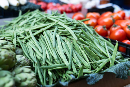 Fresh green beans on display at a farmers market, showcasing the abundance of summer harvestの写真素材