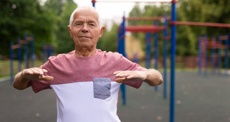 Old man warming up before training outdoorsの写真素材