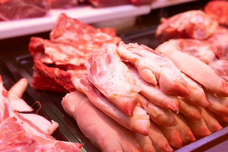 Raw pig feet on counter of butcher shop.の写真素材
