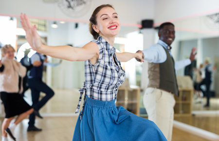 Man and woman performing jazz dance in dancing roomの写真素材