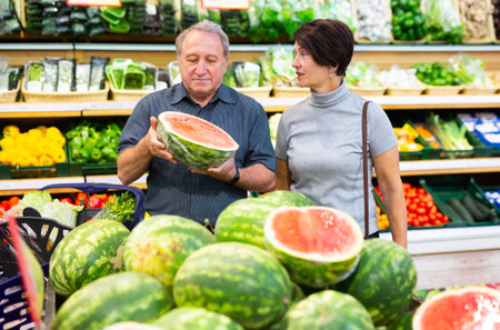 elderly husband and wife choose high-quality watermelonの写真素材