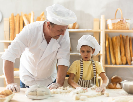 Bakers dad teaches his daughter niece to knead dough
