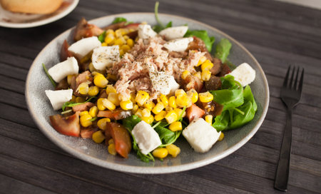 Plate of salad with tuna, corn, tomatoes and arugulaの写真素材