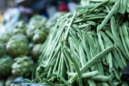 Box is filled with green beans, grocery store display case.の写真素材