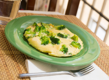 wholesome breakfast. omelet with broccoli on green plateの写真素材