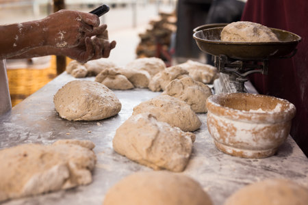 Mens hands kneading yeast dough for baking bread on the table