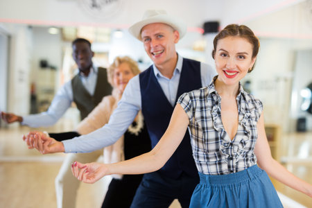 Group of different age dancers preparing swing performance