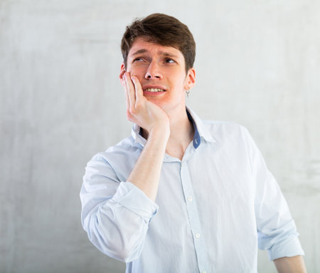 Unhappy man having a toothacheの写真素材