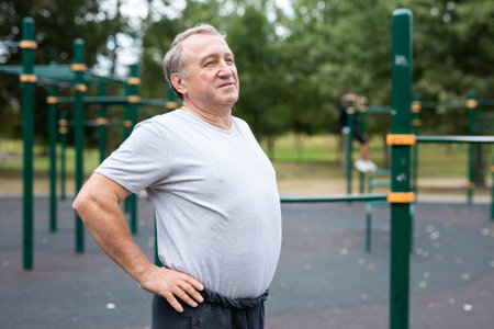 Aged man in open-air sports area
