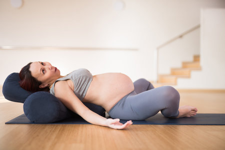 pregnant woman is engaged in yoga. Reclined Goddess Pose or Supta Baddha Konasanaの写真素材