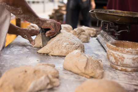 male hands knead yeast dough for baking bread