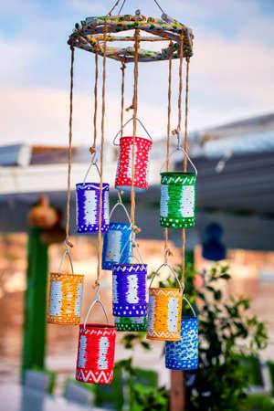 Decorative colorful tin boxes hanging at the entrance of a restaurantの写真素材