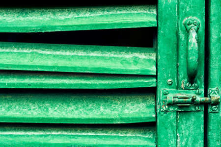 Old green blinds door with lockの写真素材