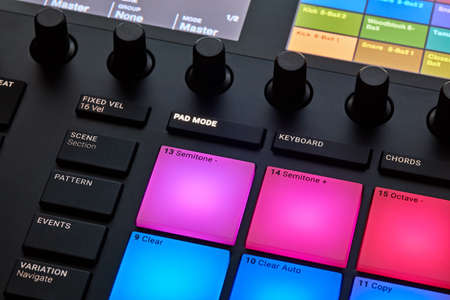 Close up view of professional studio sound recording device with colorful buttons and knobs