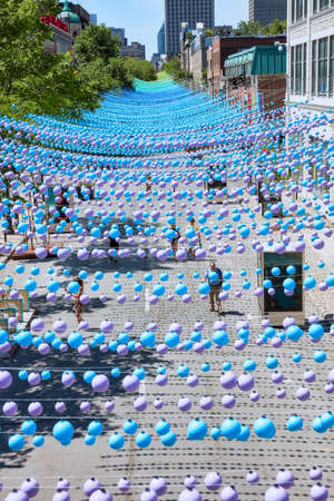 Montreal, Canada - June, 2018. Iconic colorful rainbow balls hanging over the gay village in Sainte-Catherine street of montreal, quebec, canada. Editorial use.のeditorial素材