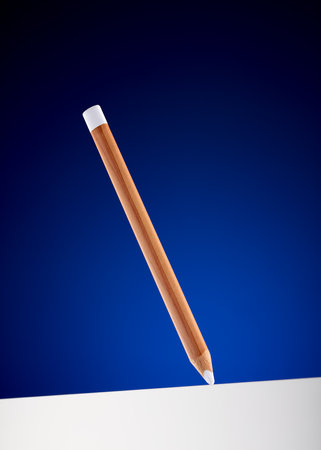 White colored wooden pencil hanging on the air drawing a thick white line. Concept of drawing, balance and creativity.の写真素材