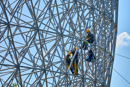 Montreal, Canada, June, 2018. Construction workers doing maintenance job on the steel bars of the biosphere environment museum in Montreal, Quebec, Canada. Editorial use.のeditorial素材