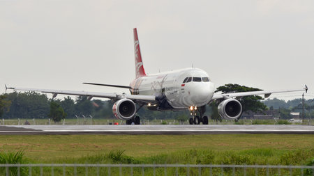 Boyolali, Central Java, Indonesia-26 December 2017: Indonesia AirAsia, PK-AZA, Airbus A320-216, lining up runway 26 of Adi Soemarmo Airport for takeoffのeditorial素材