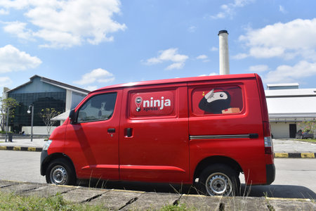 Karanganyar, Central Java, Indonesia-13 May 2023: Daihatsu Gran Max minivan of Ninja Xpress parked in De Tjolomadoe sugar museum parking lotのeditorial素材