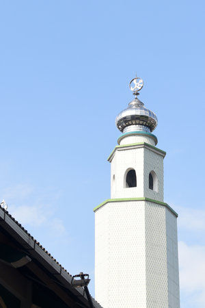 Mosque minaret against blue sky in Sukoharjo, Indonesiaの写真素材
