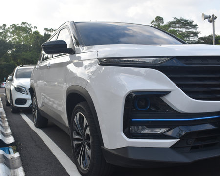 Front view of a white SUV car parked in the parking lot.の写真素材